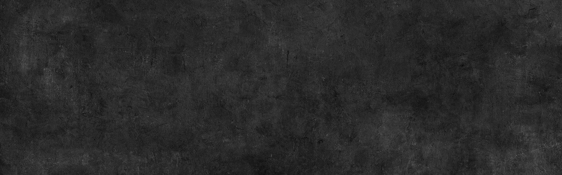 Eine anthrazit Steinwand.